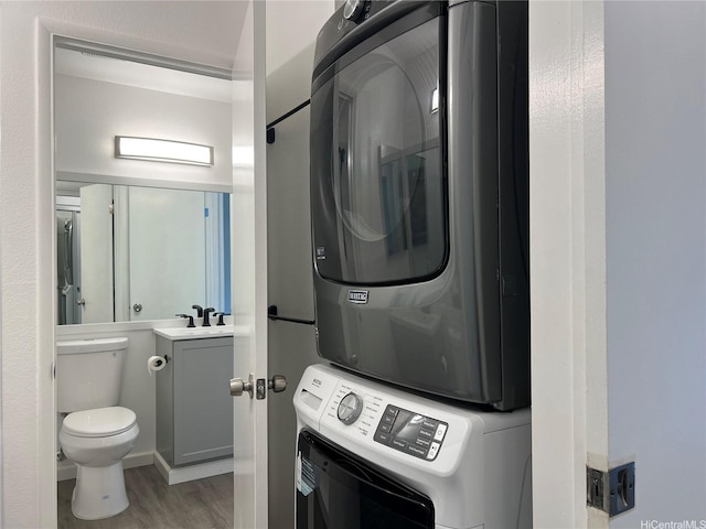 91-1089 Puamaeole St Unit 15D, Ewa Beach, HI 96706 - laundry room with estacked washer and dryer and wood finished floors