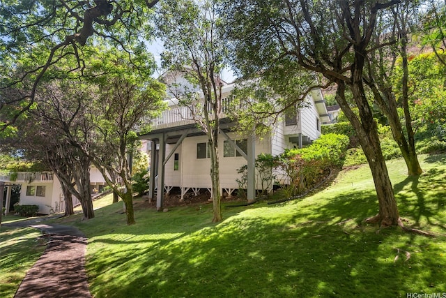 view of side of home with a lawn