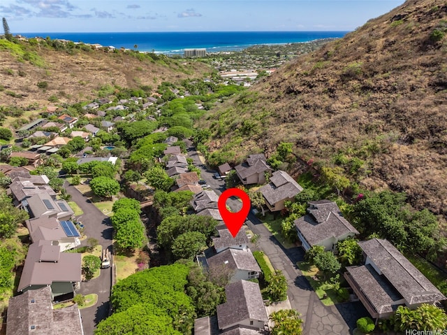 aerial view of property's location with nearby suburban area and a nearby body of water