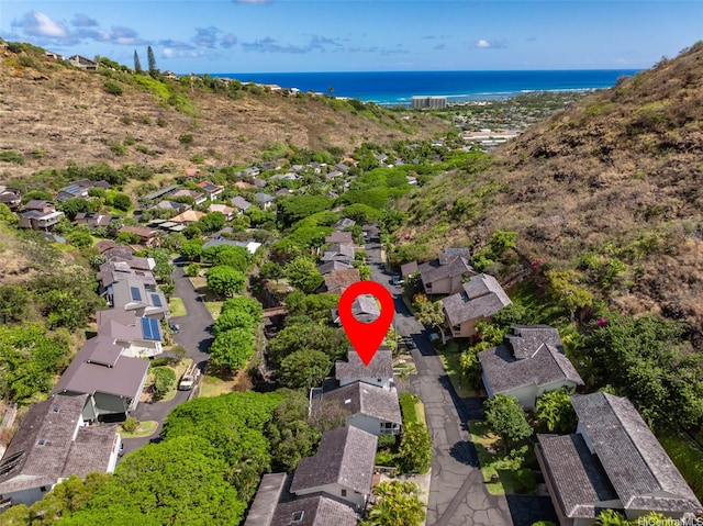view of property location featuring a nearby body of water and nearby suburban area
