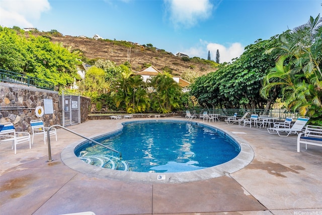 community pool with a patio area
