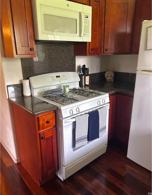 16-1873 34th Ave, Keaau, HI 96749 - kitchen featuring white appliances, dark wood-type flooring, and dark countertops