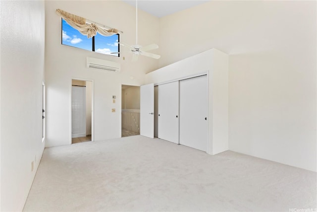 1418 Makiki St Unit A, Honolulu, HI 96814 - unfurnished bedroom featuring an AC wall unit, carpet floors, a high ceiling, ceiling fan, and a closet