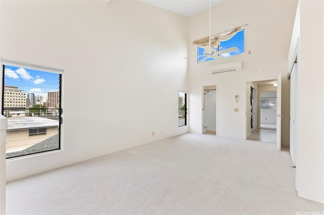 1418 Makiki St Unit A, Honolulu, HI 96814 - unfurnished room with an AC wall unit, carpet flooring, and a high ceiling