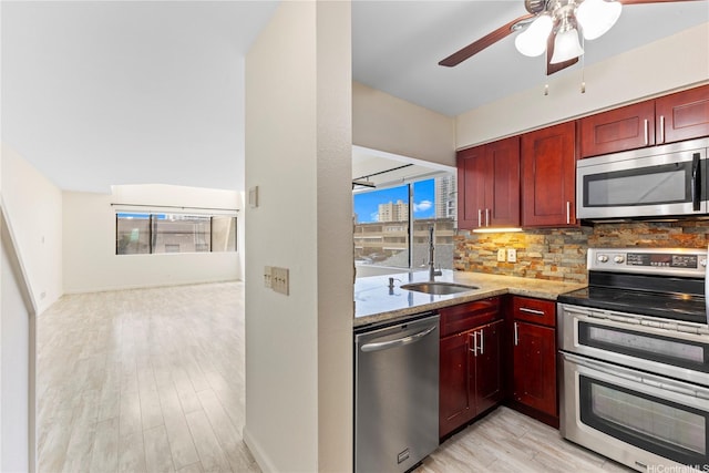 1418 Makiki St Unit A, Honolulu, HI 96814 - kitchen with appliances with stainless steel finishes, dark brown cabinets, light stone counters, backsplash, and light wood-type flooring
