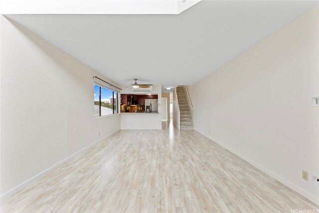 1418 Makiki St Unit A, Honolulu, HI 96814 - unfurnished living room featuring stairs, light wood-style floors, and a ceiling fan