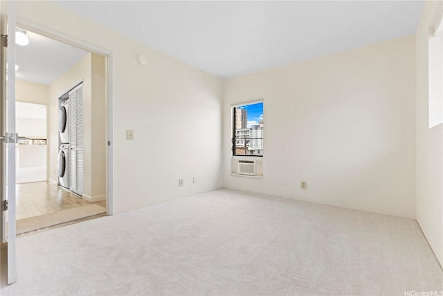 1418 Makiki St Unit A, Honolulu, HI 96814 - spare room featuring stacked washer / dryer, carpet flooring, and cooling unit