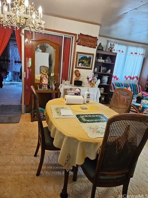3844 Likini St, Honolulu, HI 96818 - dining space featuring light colored carpet and a chandelier