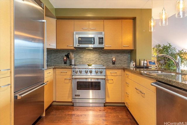 1837 Kalakaua Ave Unit 808, Honolulu, HI 96815 - kitchen featuring high quality appliances, dark wood-type flooring, backsplash, dark stone countertops, and hanging light fixtures