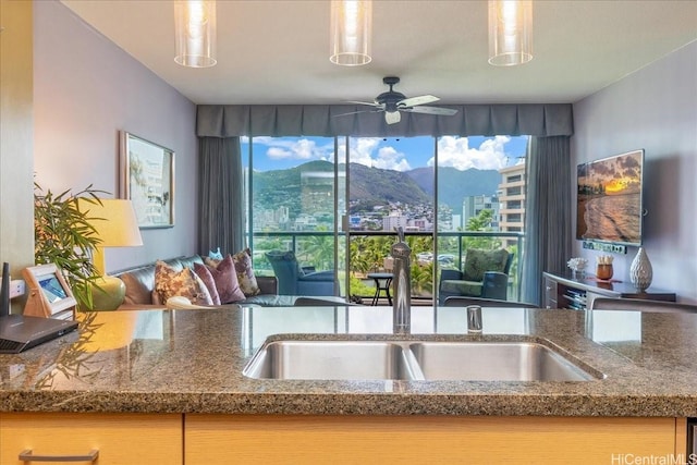 1837 Kalakaua Ave Unit 808, Honolulu, HI 96815 - kitchen with a ceiling fan, dark stone counters, and open floor plan