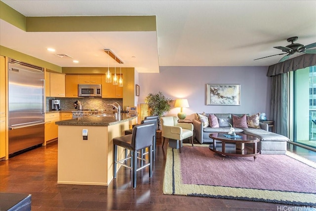 1837 Kalakaua Ave Unit 808, Honolulu, HI 96815 - kitchen featuring appliances with stainless steel finishes, open floor plan, a peninsula, tasteful backsplash, and a kitchen bar