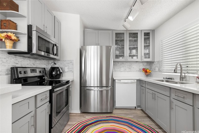 91-1145 Laaulu St Unit 12B, Ewa Beach, HI 96706 - kitchen featuring appliances with stainless steel finishes, gray cabinetry, a textured ceiling, tasteful backsplash, and light countertops