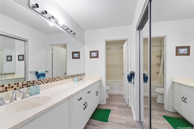 91-1145 Laaulu St Unit 12B, Ewa Beach, HI 96706 - full bathroom with double vanity, wood finished floors, a textured ceiling, and bathtub / shower combination