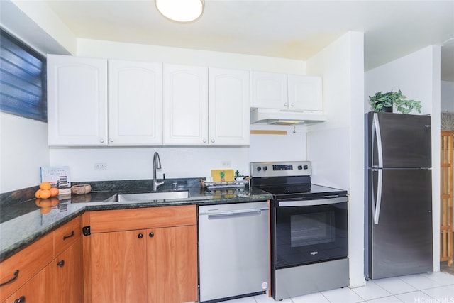 1423 Emerson St Unit 105, Honolulu, HI 96813 - kitchen featuring stainless steel appliances, under cabinet range hood, dark stone countertops, white cabinetry, and light tile patterned flooring