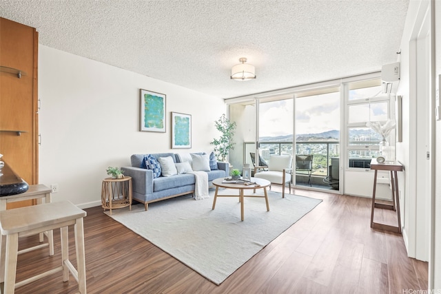 1133 Waimanu St Unit 2503, Honolulu, HI 96814 - living area with a textured ceiling, wood finished floors, and floor to ceiling windows