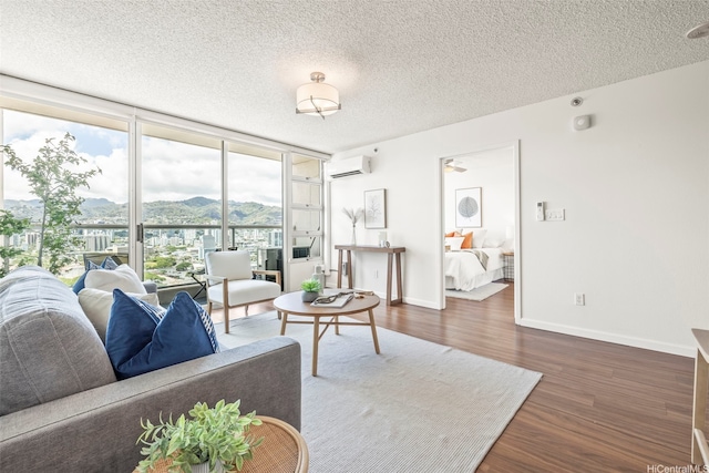 1133 Waimanu St Unit 2503, Honolulu, HI 96814 - living room with a wall mounted air conditioner, a mountain view, dark wood-style floors, expansive windows, and a textured ceiling