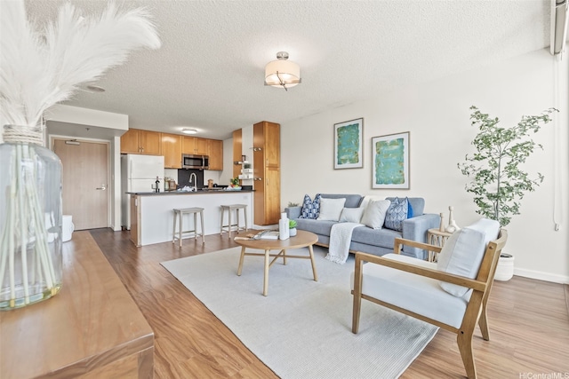 1133 Waimanu St Unit 2503, Honolulu, HI 96814 - living room with wood finished floors and a textured ceiling