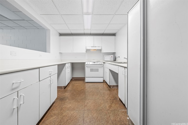1133 Waimanu St Unit 2503, Honolulu, HI 96814 - kitchen featuring white appliances, a paneled ceiling, under cabinet range hood, white cabinets, and light countertops