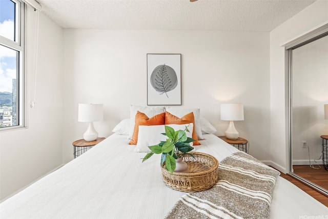 1133 Waimanu St Unit 2503, Honolulu, HI 96814 - bedroom with wood finished floors, a textured ceiling, and a closet