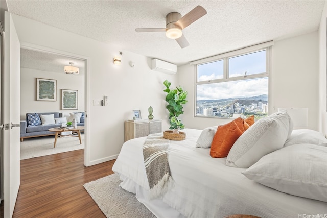 1133 Waimanu St Unit 2503, Honolulu, HI 96814 - bedroom with dark wood-style floors, a textured ceiling, a wall mounted air conditioner, and ceiling fan