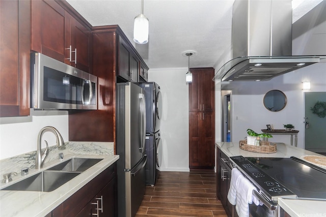 94-559 Makohilani St Unit 1071, Mililani, HI 96789 - kitchen with stainless steel appliances, island range hood, dark brown cabinets, stacked washer and clothes dryer, and dark wood-style flooring