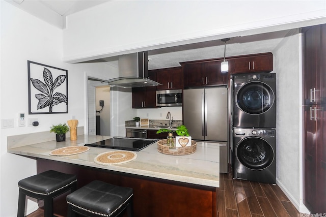 94-559 Makohilani St Unit 1071, Mililani, HI 96789 - kitchen with stacked washer / drying machine, island exhaust hood, stainless steel appliances, dark wood-style flooring, and a peninsula