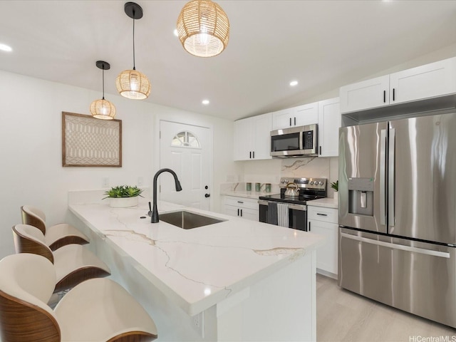 2078 Akaikai Loop, Pearl City, HI 96782 - kitchen featuring appliances with stainless steel finishes, white cabinets, a peninsula, recessed lighting, and light stone counters