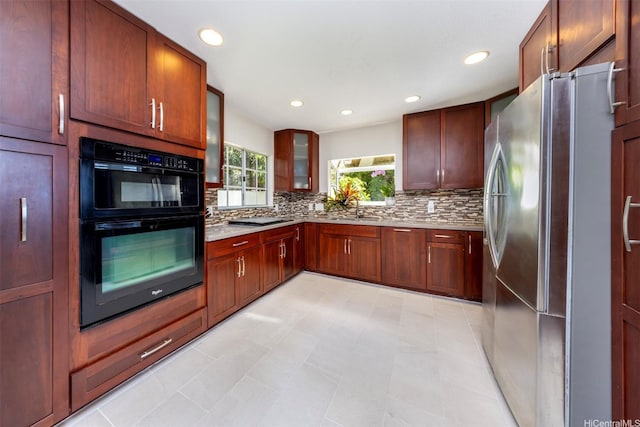 4959 Maunalani Cir Unit 3, Honolulu, HI 96816 - kitchen featuring freestanding refrigerator, backsplash, light countertops, glass insert cabinets, and recessed lighting