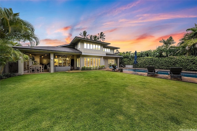 1319 Mokulua Dr, Kailua, HI 96734 - back of house at dusk with a patio