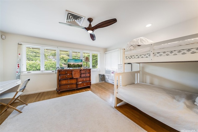 1319 Mokulua Dr, Kailua, HI 96734 - bedroom featuring multiple windows, wood finished floors, and a ceiling fan
