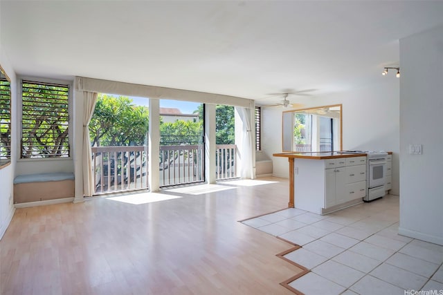 84-755 Ala Mahiku St Unit 74B, Waianae, HI 96792 - kitchen with electric range, white cabinets, light wood-style floors, ceiling fan, and open floor plan