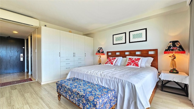 1777 Ala Moana Blvd Unit 2436, Honolulu, HI 96815 - bedroom featuring a wall mounted AC and light wood-style floors