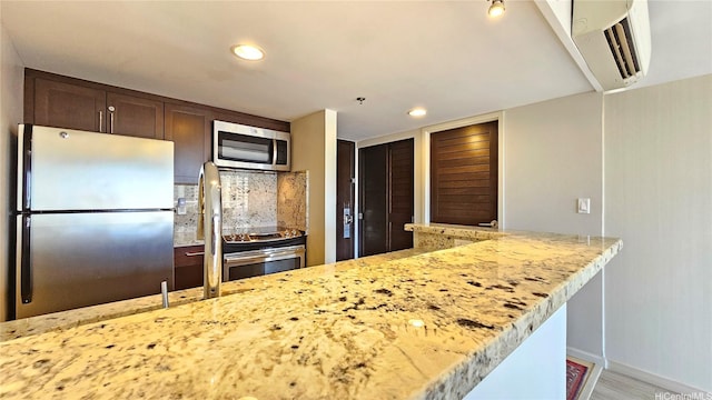 1777 Ala Moana Blvd Unit 2436, Honolulu, HI 96815 - kitchen with stainless steel appliances, an AC wall unit, dark brown cabinets, recessed lighting, and light stone counters