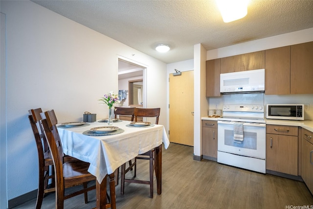 7000 Hawaii Kai Dr Unit 3605, Honolulu, HI 96825 - kitchen featuring white appliances, wood finished floors, light countertops, a textured ceiling, and brown cabinets