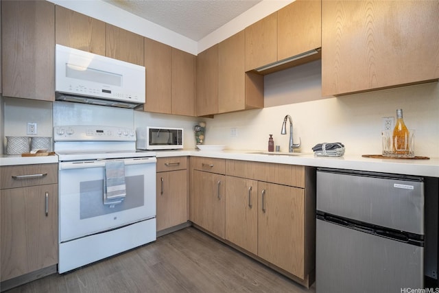 7000 Hawaii Kai Dr Unit 3605, Honolulu, HI 96825 - kitchen featuring white appliances, light countertops, wood finished floors, and a textured ceiling