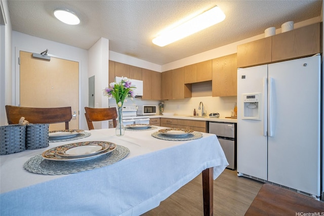 7000 Hawaii Kai Dr Unit 3605, Honolulu, HI 96825 - kitchen featuring white appliances, light countertops, wood finished floors, electric panel, and a textured ceiling