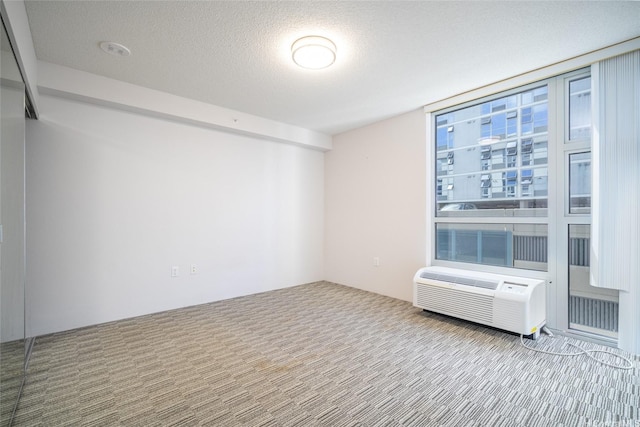 7000 Hawaii Kai Dr Unit 3605, Honolulu, HI 96825 - unfurnished room with carpet, a wall mounted AC, and a textured ceiling