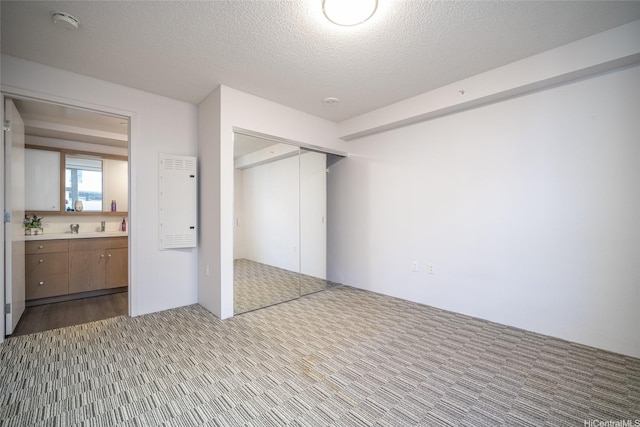 7000 Hawaii Kai Dr Unit 3605, Honolulu, HI 96825 - unfurnished bedroom with a closet, carpet flooring, and a textured ceiling