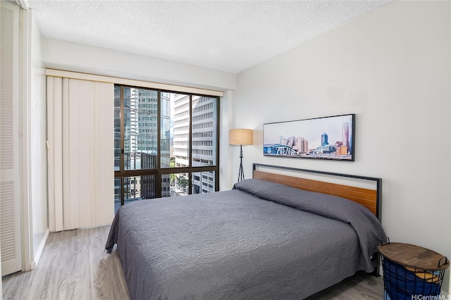 225 Queen St Unit 9E, Honolulu, HI 96813 - bedroom with wood finished floors and a textured ceiling