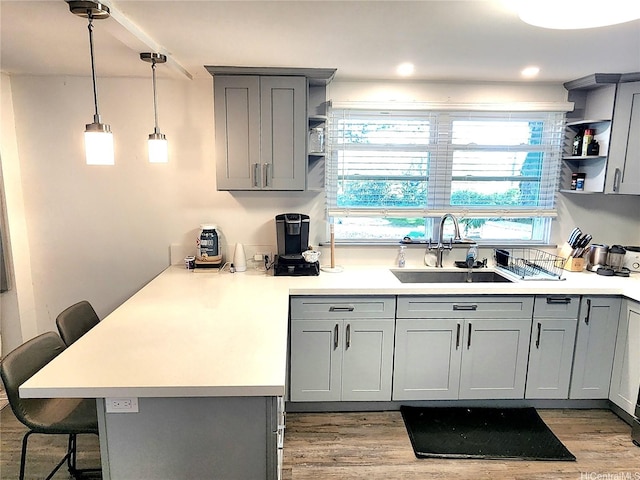 2056 Manoa Rd, Honolulu, HI 96822 - kitchen featuring gray cabinets, open shelves, a peninsula, and a kitchen breakfast bar