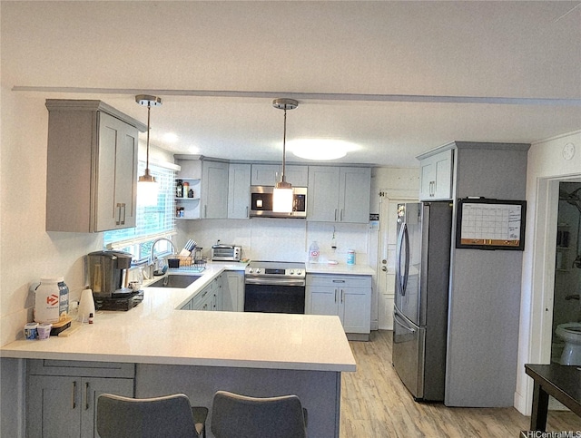 2056 Manoa Rd, Honolulu, HI 96822 - kitchen with stainless steel appliances, gray cabinets, a peninsula, and light countertops