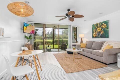 57-101 Kuilima Dr Unit 168, Kahuku, HI 96731 - living area with ceiling fan, wood finished floors, and wainscoting