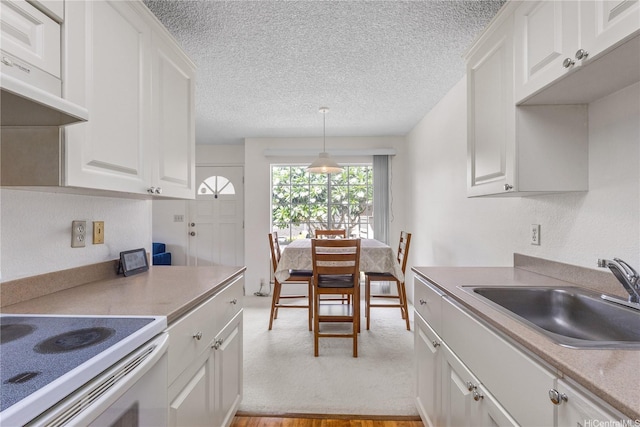 94-1359 Kulewa Loop Unit 16S, Waipahu, HI 96797 - kitchen with a textured ceiling, white cabinets, light countertops, decorative light fixtures, and white electric stove