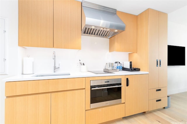 1390 Kapiolani Blvd Unit 3808, Honolulu, HI 96814 - kitchen featuring range hood, oven, light countertops, and light brown cabinetry