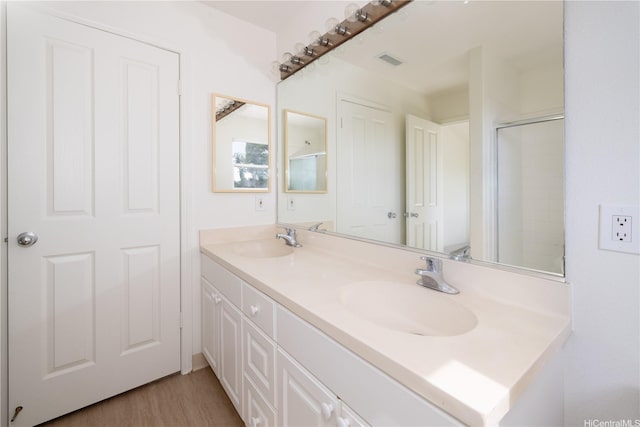 91-1051 Keoneula Blvd Unit E2, Ewa Beach, HI 96706 - full bath with double vanity, wood finished floors, and a shower with shower door