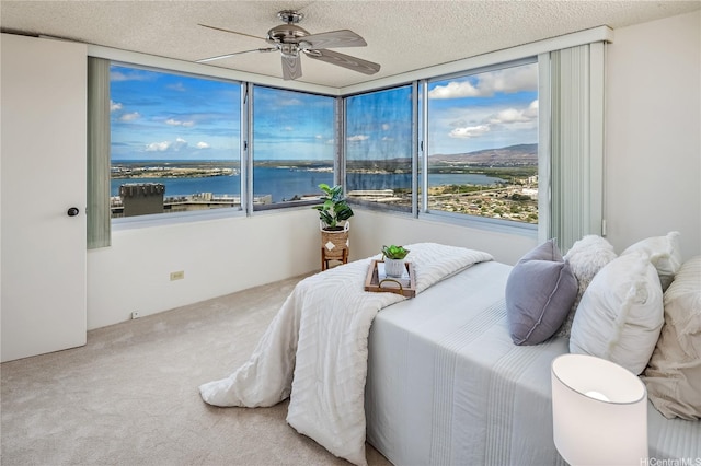 98-288 Kaonohi St Unit 3901, Aiea, HI 96701 - carpeted bedroom featuring a water view, a textured ceiling, and ceiling fan
