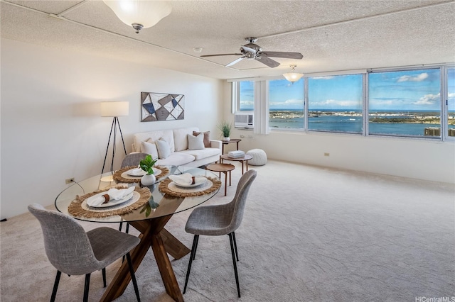 98-288 Kaonohi St Unit 3901, Aiea, HI 96701 - dining area with carpet flooring, ceiling fan, a textured ceiling, a water view, and cooling unit
