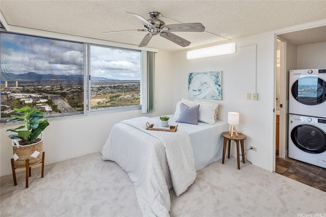 98-288 Kaonohi St Unit 3901, Aiea, HI 96701 - carpeted bedroom with estacked washer and dryer, a mountain view, a ceiling fan, and a textured ceiling