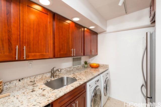 2333 Kapiolani Blvd Unit 2707, Honolulu, HI 96826 - washroom featuring washer and dryer and cabinet space