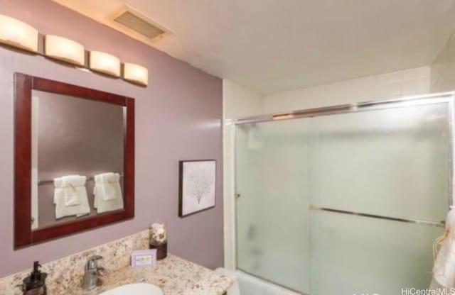 2333 Kapiolani Blvd Unit 2707, Honolulu, HI 96826 - bathroom with vanity and combined bath / shower with glass door